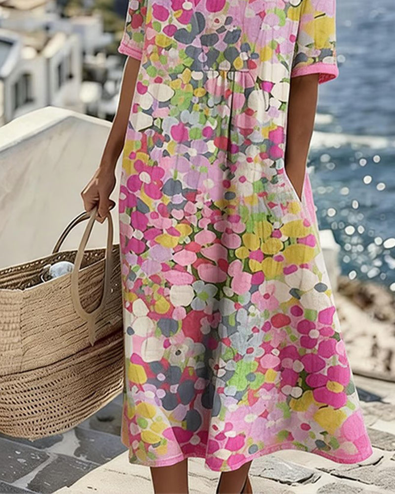 Coraline pink floral midi dress, back view showing pleated waist
