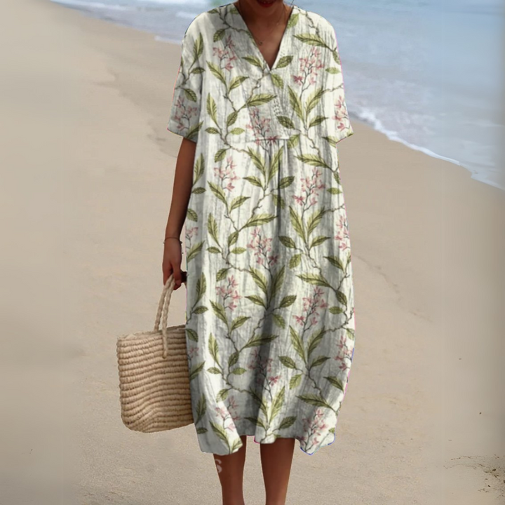 Florence leafy print V-neck midi dress, front view on model at the beach