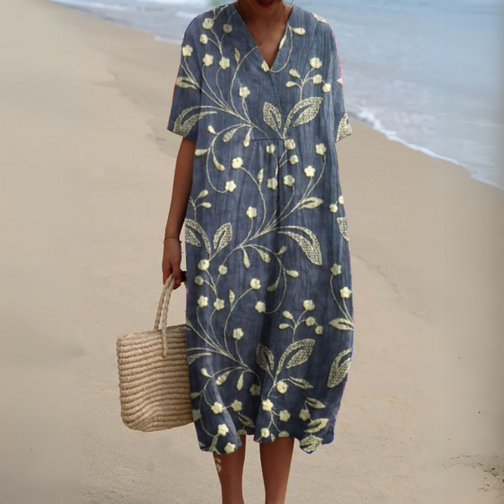 Florence blue floral V-neck midi dress, front view on model at the beach