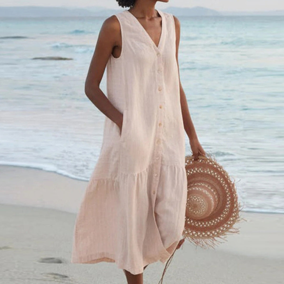 Harlow sleeveless V-neck midi shirt dress in beige, front view on beach