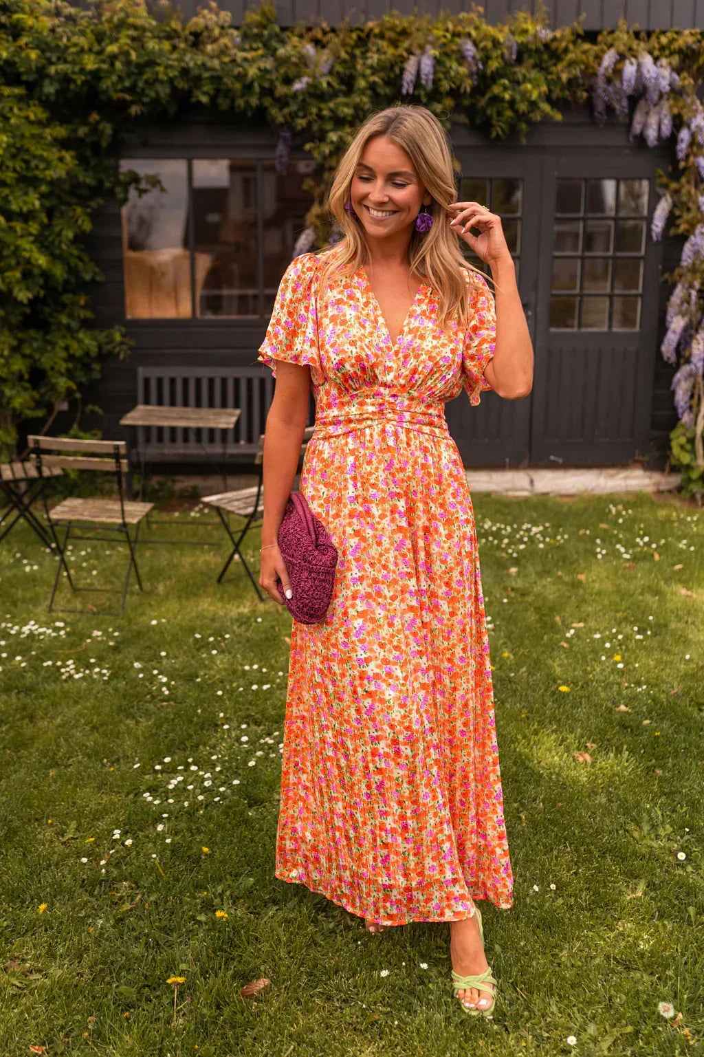 Margot floral V-neck flutter sleeve maxi dress, front view in garden setting