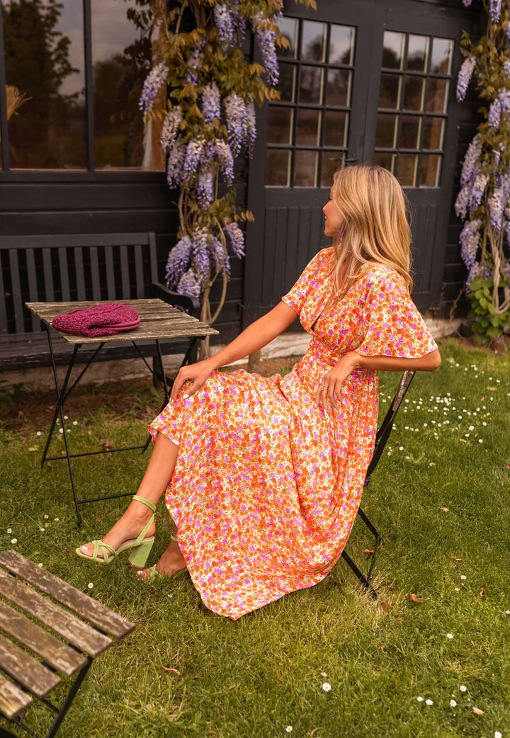 Margot floral maxi dress, seated side profile view