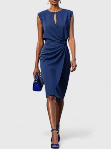 Marguerite navy keyhole wrap midi dress, front view with clutch bag