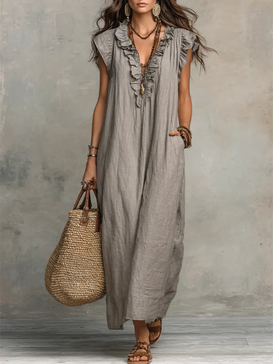 Rosalind grey boho ruffle V-neck maxi dress against textured backdrop