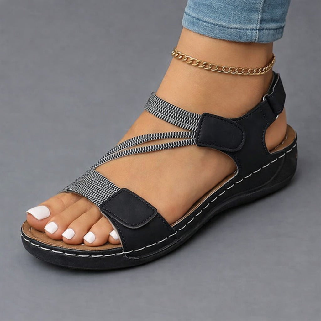 Rosalind strappy adjustable wedge sandals in black, worn on foot