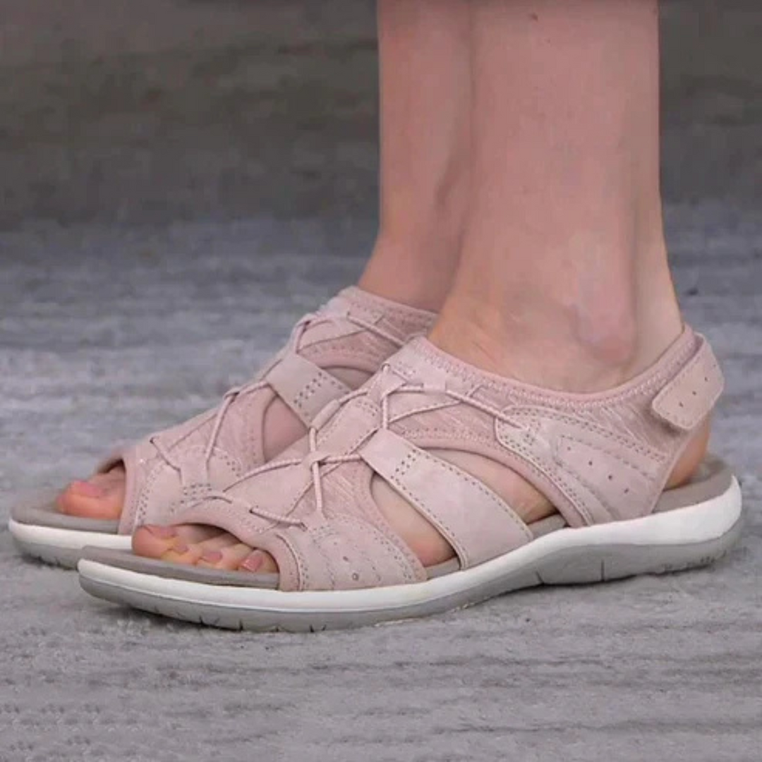 Sabine pink strappy open toe sandals worn on feet, side view