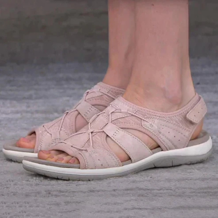 Sabine pink strappy open toe sandals worn on feet, side view
